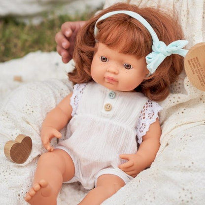 Miniland 38cm red haired girl doll being held by a child