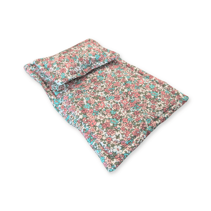 Pink floral doll quilt and pillow styled in a doll basket