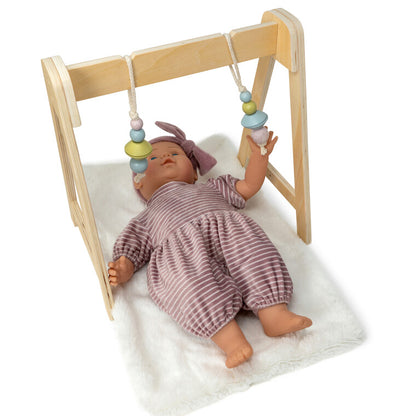 By Astrup doll activity gym shown with a doll on the fleecy mat