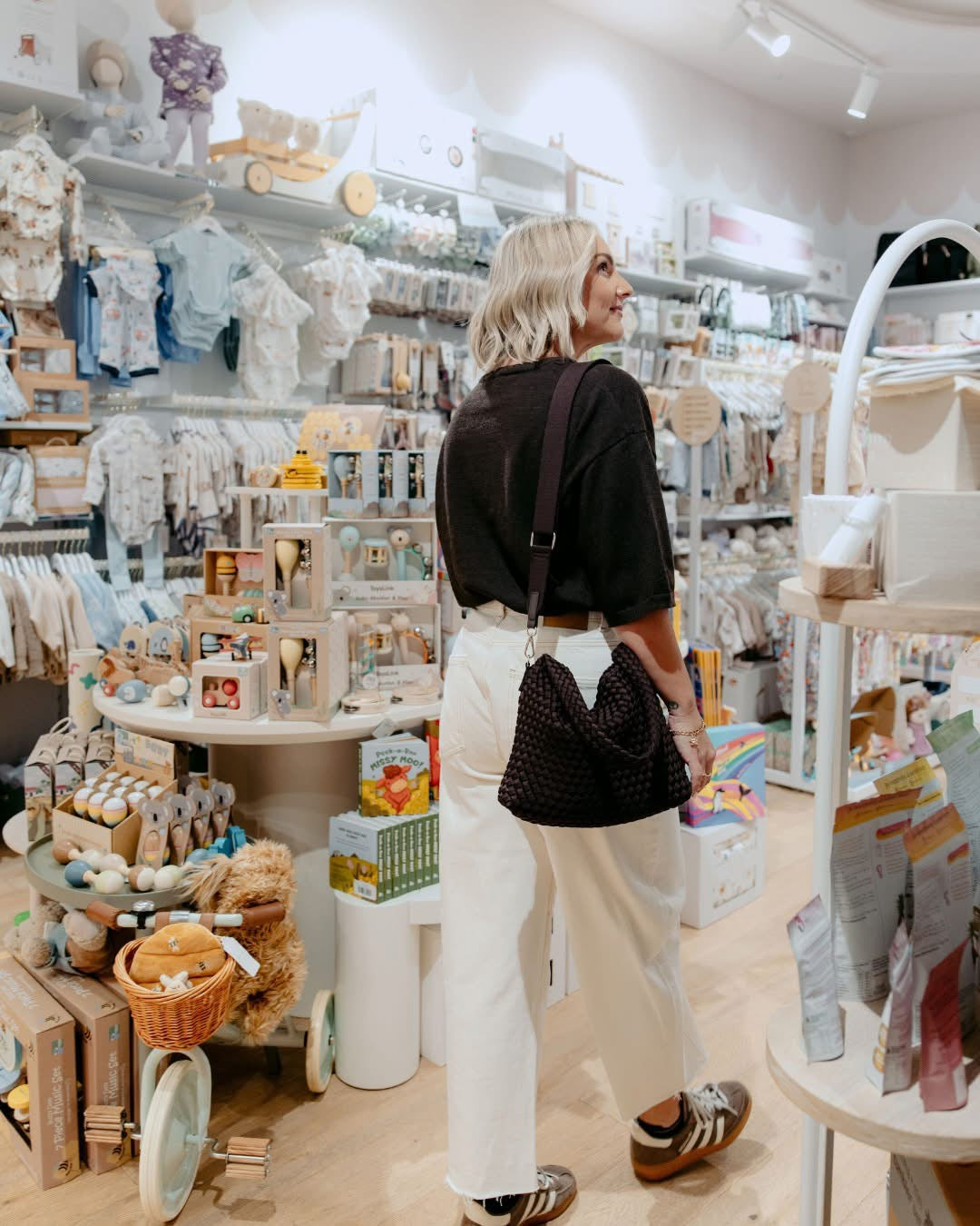 Woman shopping in a store with shelves stocked with various items