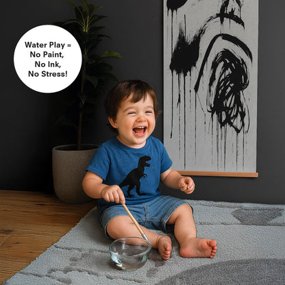 Toddler smiling with brush and bowl of water playing with magic water poster