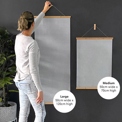 Person holding up two Kids Magic Water Posters in 50x70cm and 50x120cm sizes for scale