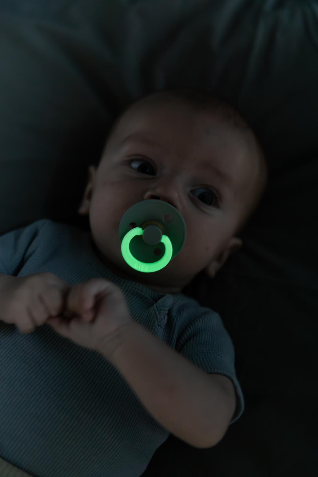 BIBS Round Glow Baby Blue pacifier in use