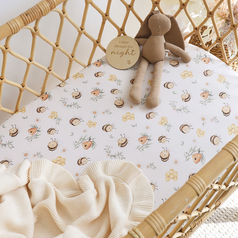 Snuggle Hunny Bumblebees organic bassinet sheet on a bassinet