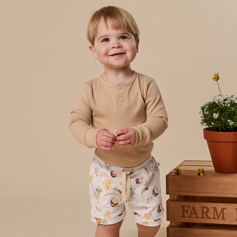 Baby wearing Snuggle Hunny Bumblebees organic shorts