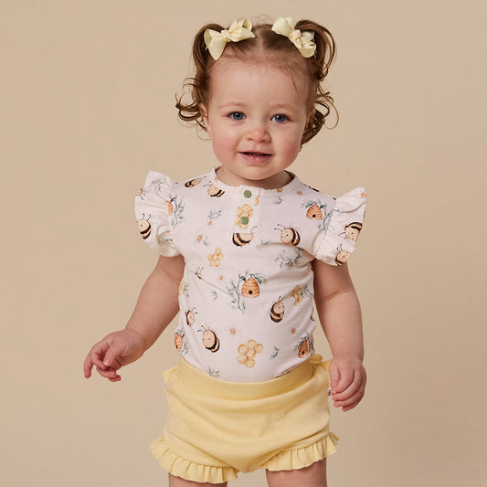 Baby wearing Snuggle Hunny Bumblebees short sleeve organic bodysuit with frill