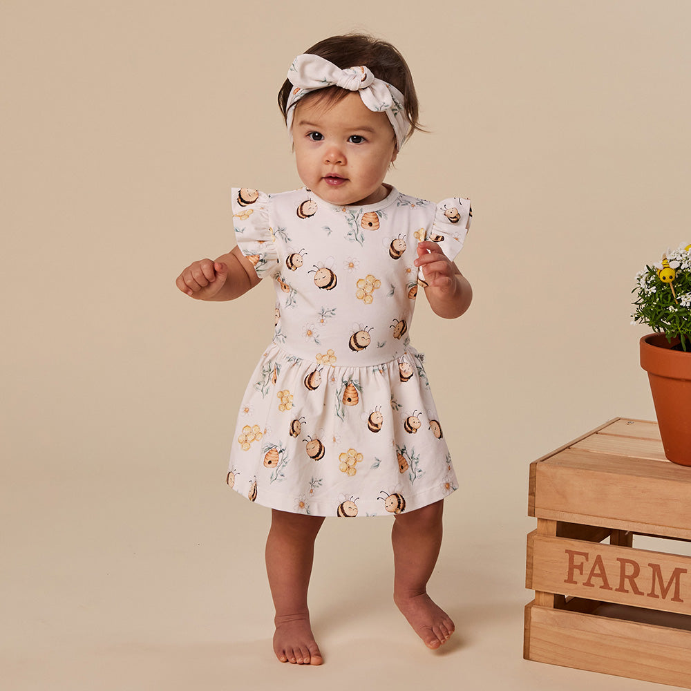 Baby wearing Snuggle Hunny Bumblebees short sleeve organic dress
