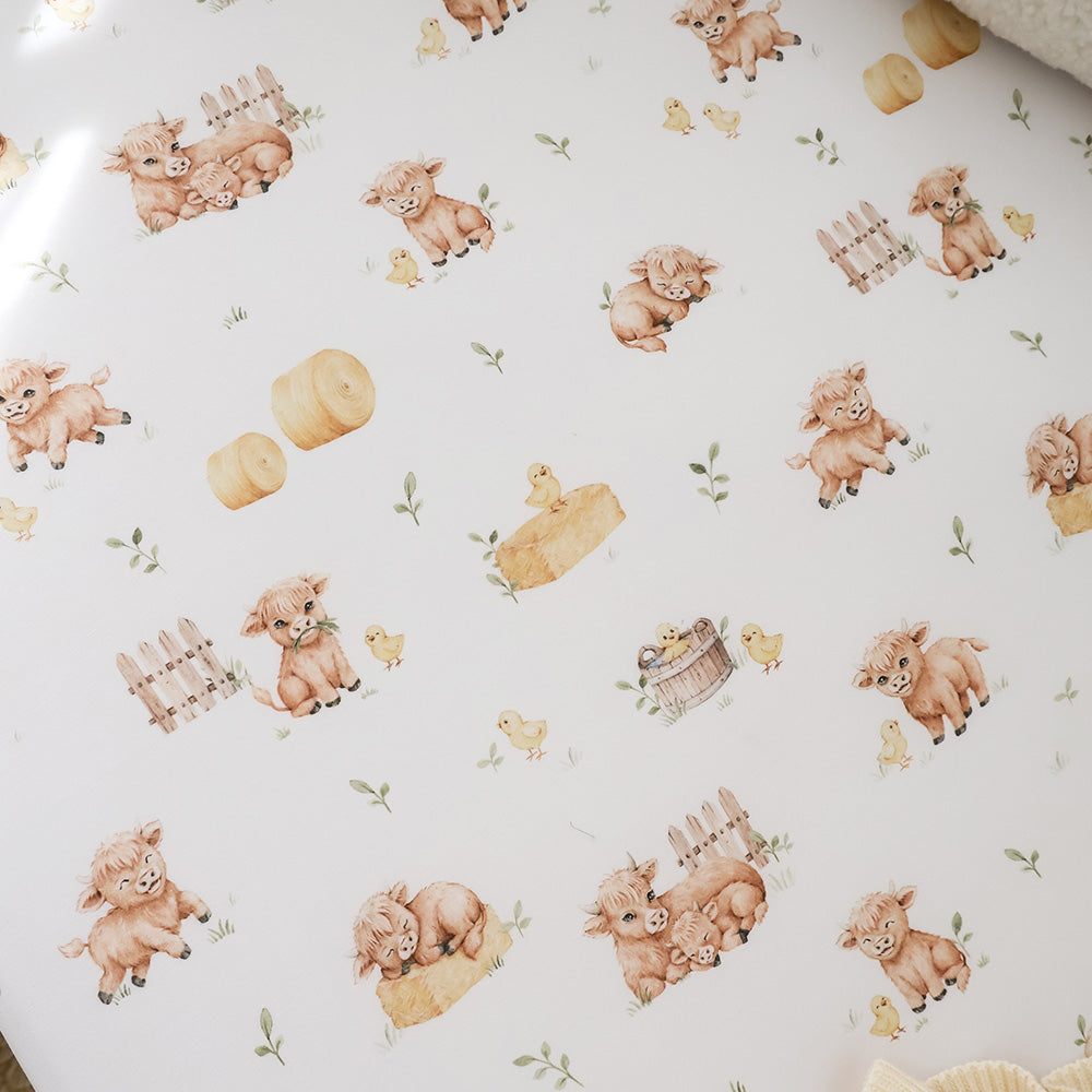 Snuggle Hunny Highland Cows fitted cot sheet lifestyle