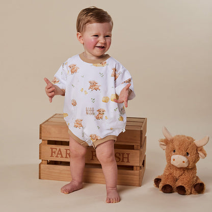 Baby wearing Snuggle Hunny Highland Cows organic oversized romper