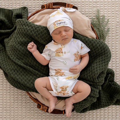 Baby wearing Snuggle Hunny Highland Cows short sleeve organic bodysuit