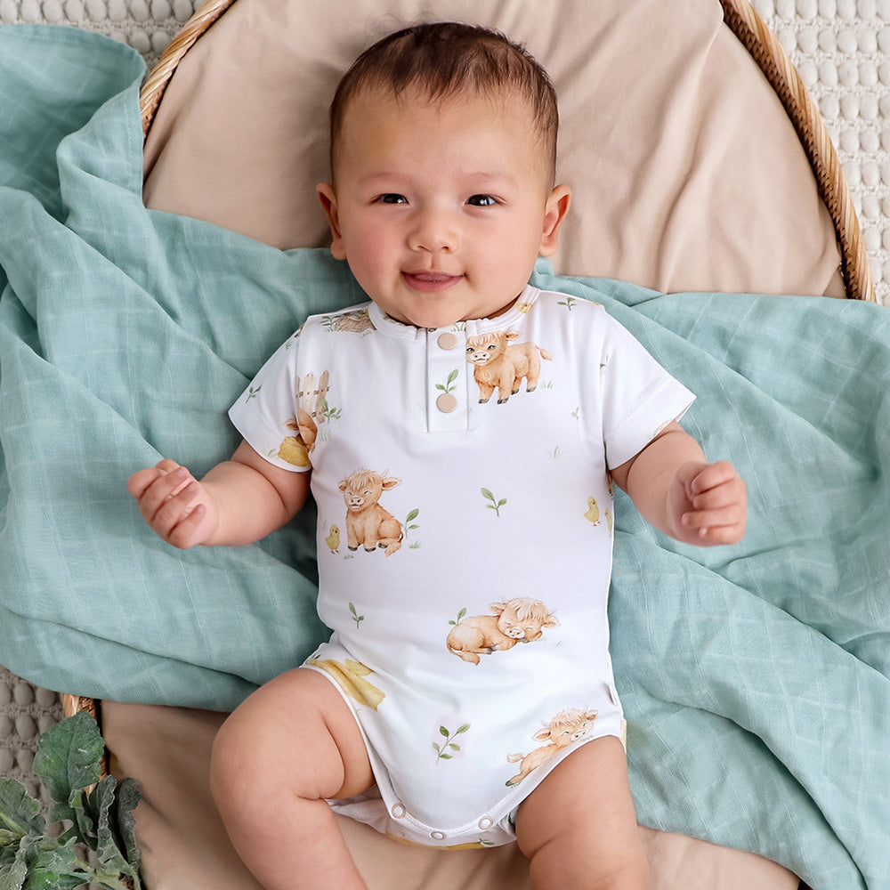 Snuggle Hunny Highland Cows bodysuit on baby