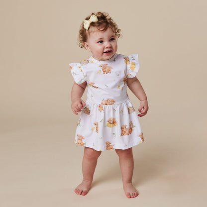 Baby wearing Snuggle Hunny Highland Cows short sleeve organic dress