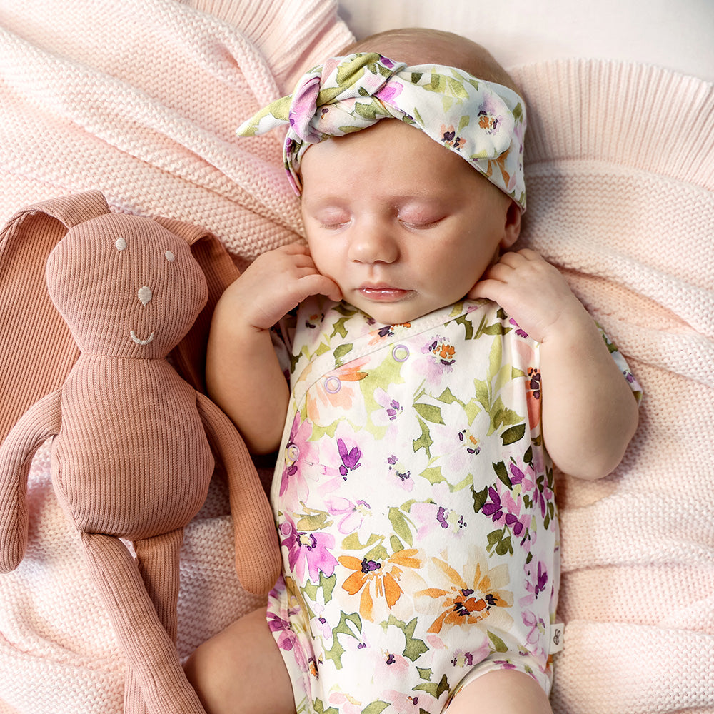Baby wearing Snuggle Hunny Isla short sleeve organic kimono bodysuit