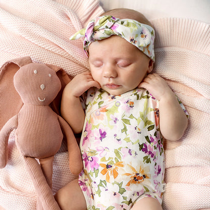 Baby wearing Snuggle Hunny Isla short sleeve organic kimono bodysuit