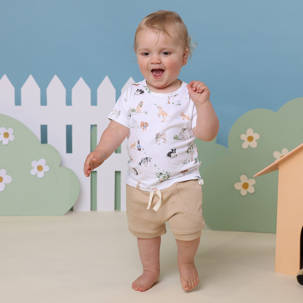 Baby wearing Snuggle Hunny Pebble organic shorts