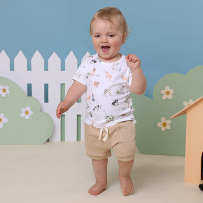 Baby wearing Snuggle Hunny Pebble organic shorts