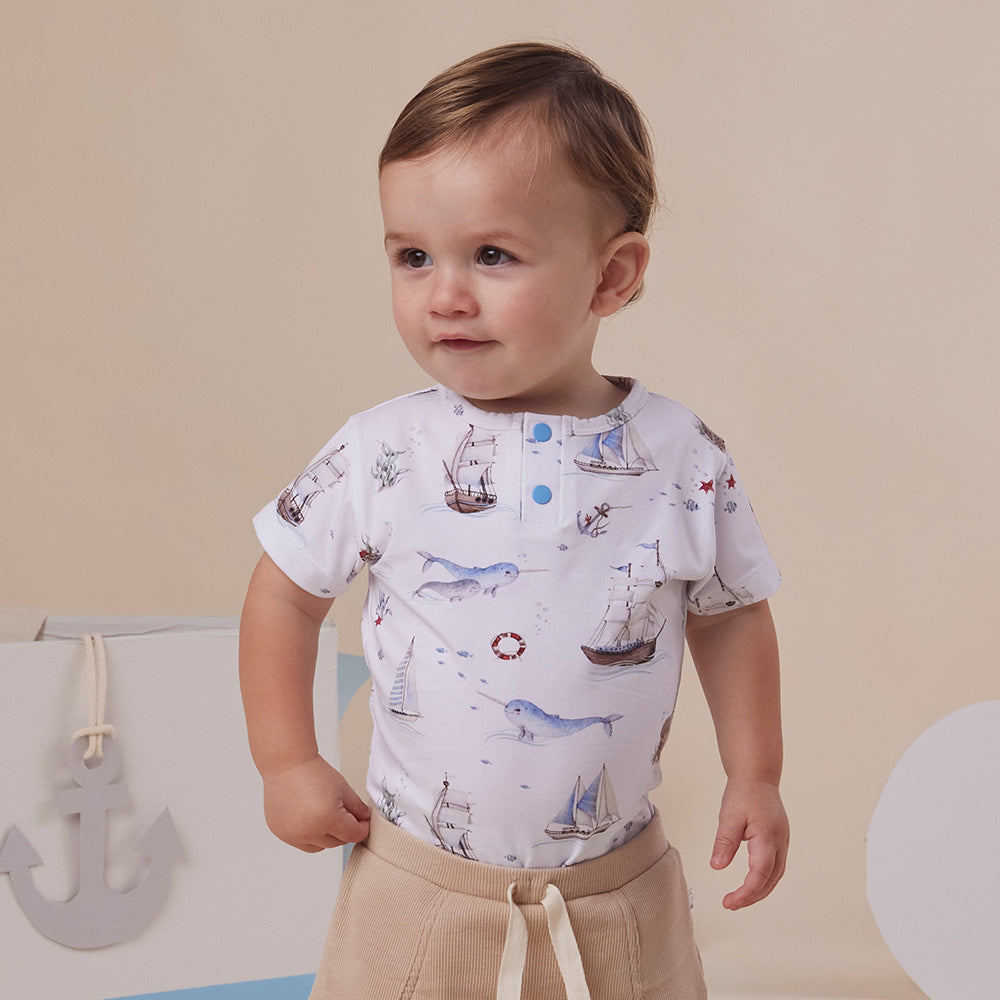Baby wearing Snuggle Hunny Set Sail short sleeve organic bodysuit